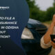 Man in Odisha checking phone next to a damaged car after an accident, representing motor insurance claim process